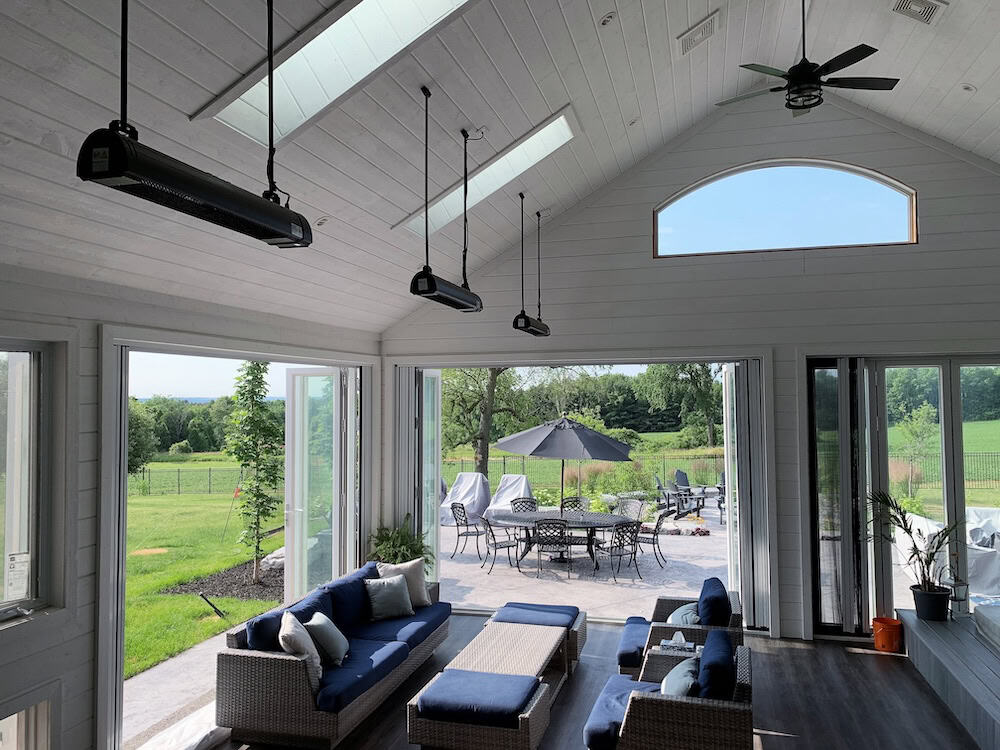 Ceiling Suspended Mounted AURA heaters in a spacious white enclosed residential porch in CA