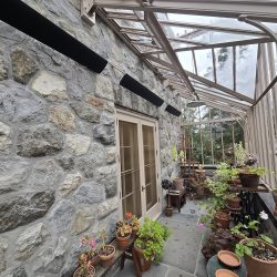 Aura Shadow Series outdoor heaters installed in a residential greenhouse