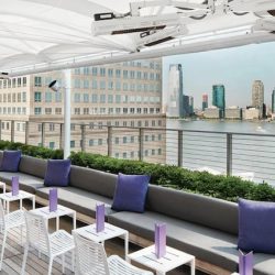Custom, HeatingSolutionsUSA designed, specified, supplied installation with Solaira CosyXL H1heaters installed under umbrella – Conrad Rooftop patio NYC