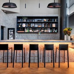 Circular Solaira Radius Heaters hanging above a modern restaurant bar